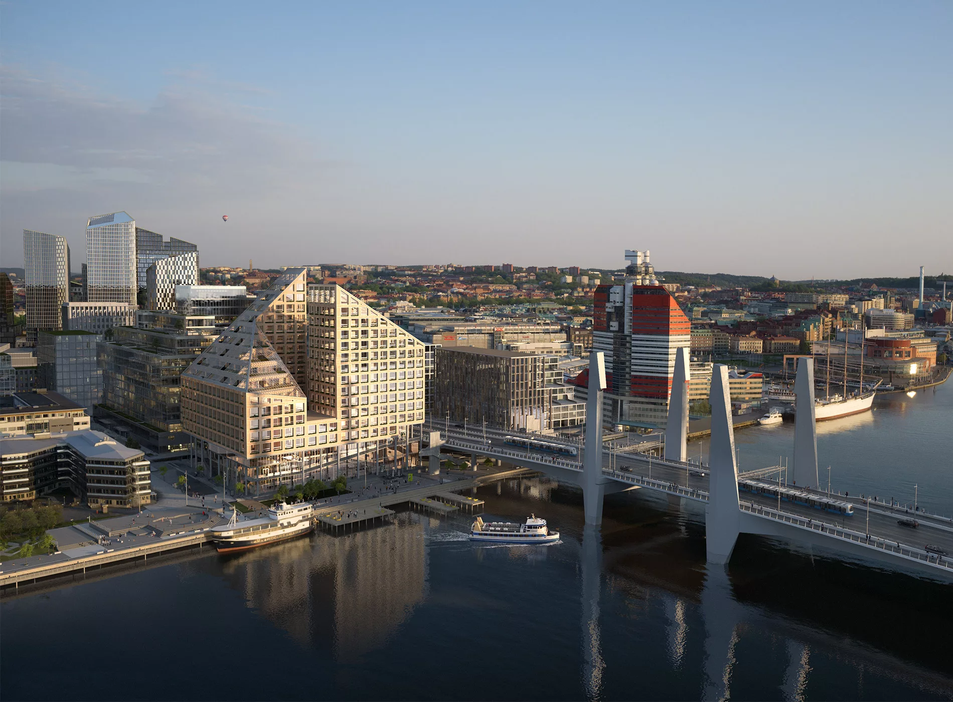 En stadsvy med moderna byggnader, en bro och vatten i förgrunden.