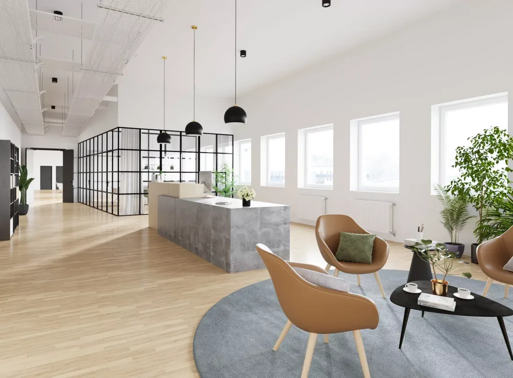 2. Ett ljust kontorsrum med vit inredning, marmorbänk, designstolar och stora fönster som släpper in naturligt ljus.