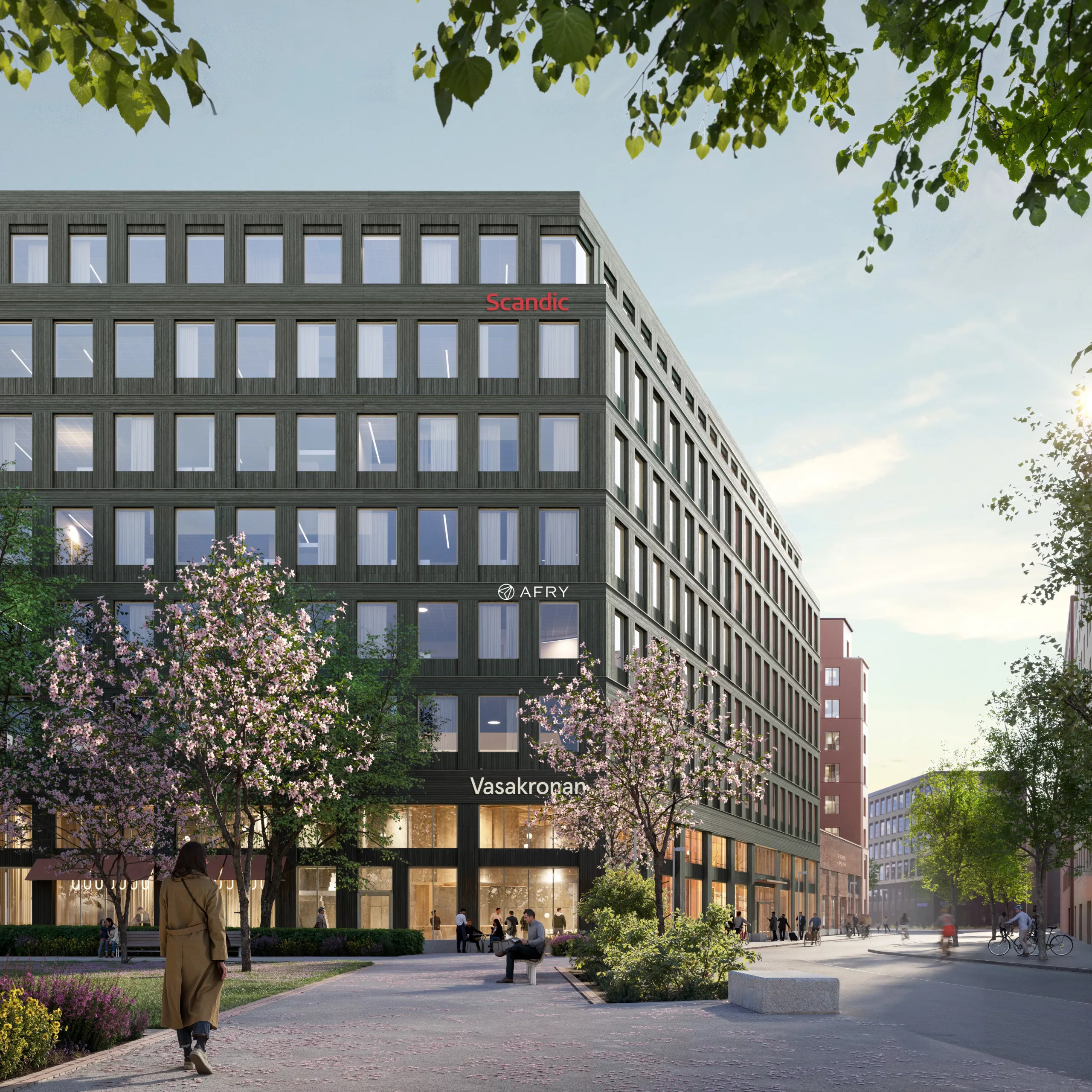- Exteriör av en modern kontorsbyggnad med gröna fasader och stora fönster. Området runt byggnaden har träd, planteringar och gångvägar, med människor som rör sig.