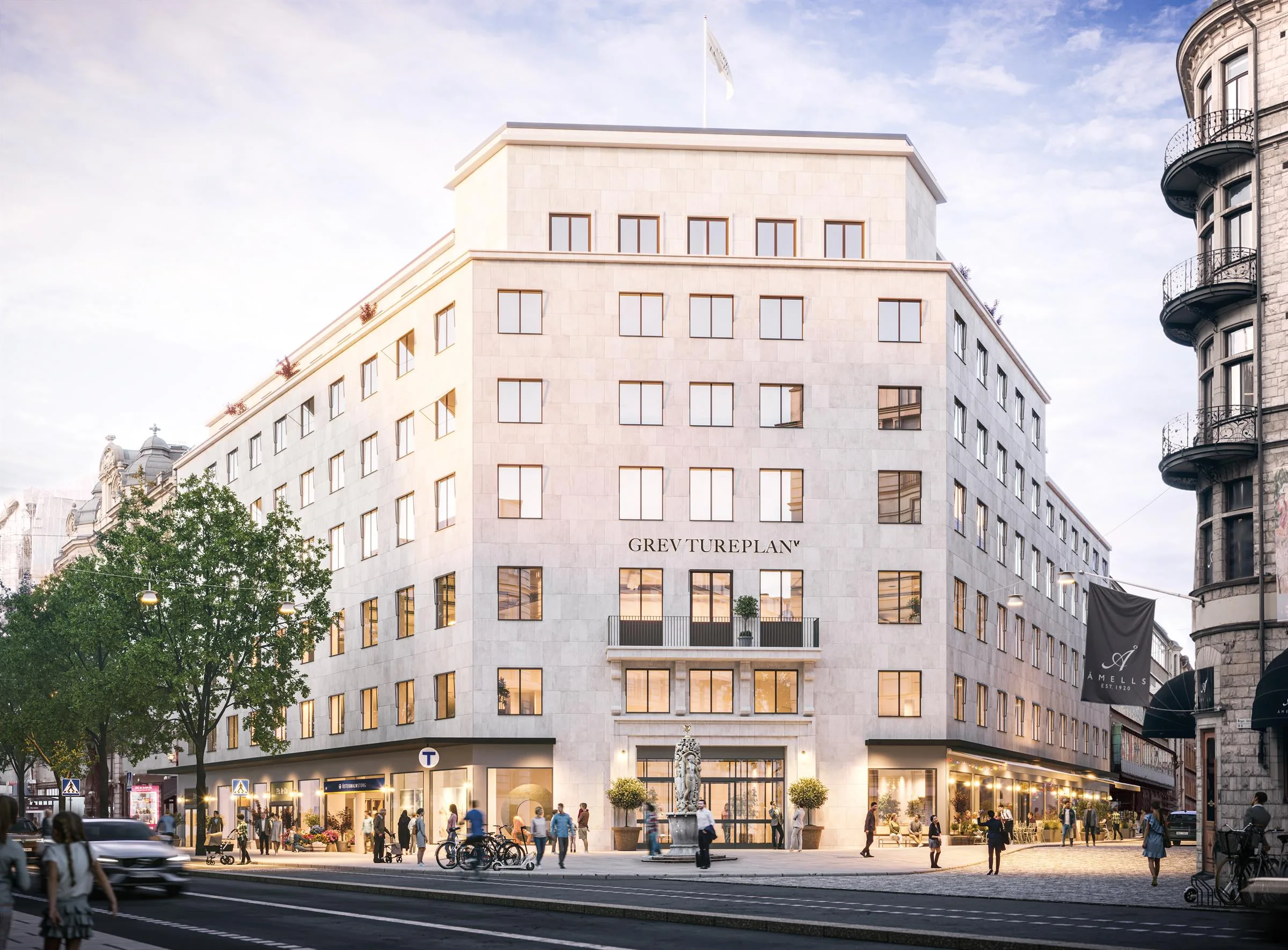 En ljus byggnad i klassisk stil med stora fönster och ett hotellnamn synligt på fasaden.