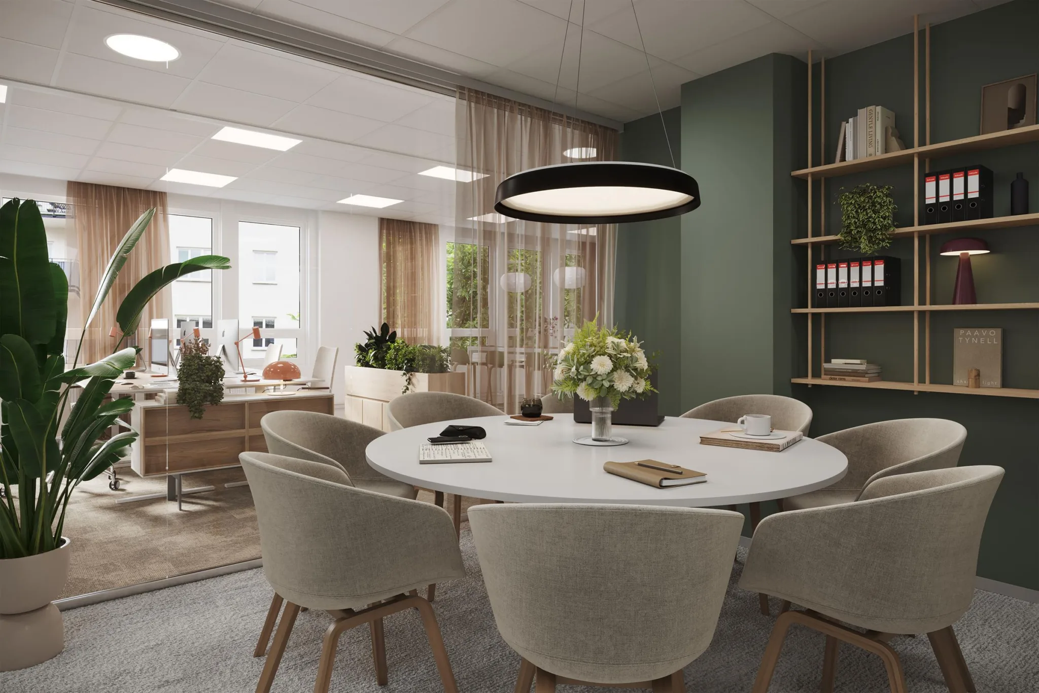 2. Ett mötesrum med ett runt bord, sex stolar och en modern lampa ovanför.