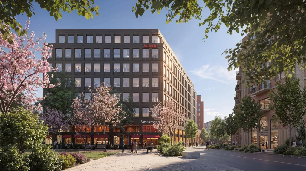 En bred stadsgata kantad av träd och en stor byggnad med fönster och butiker på bottenvåningen.