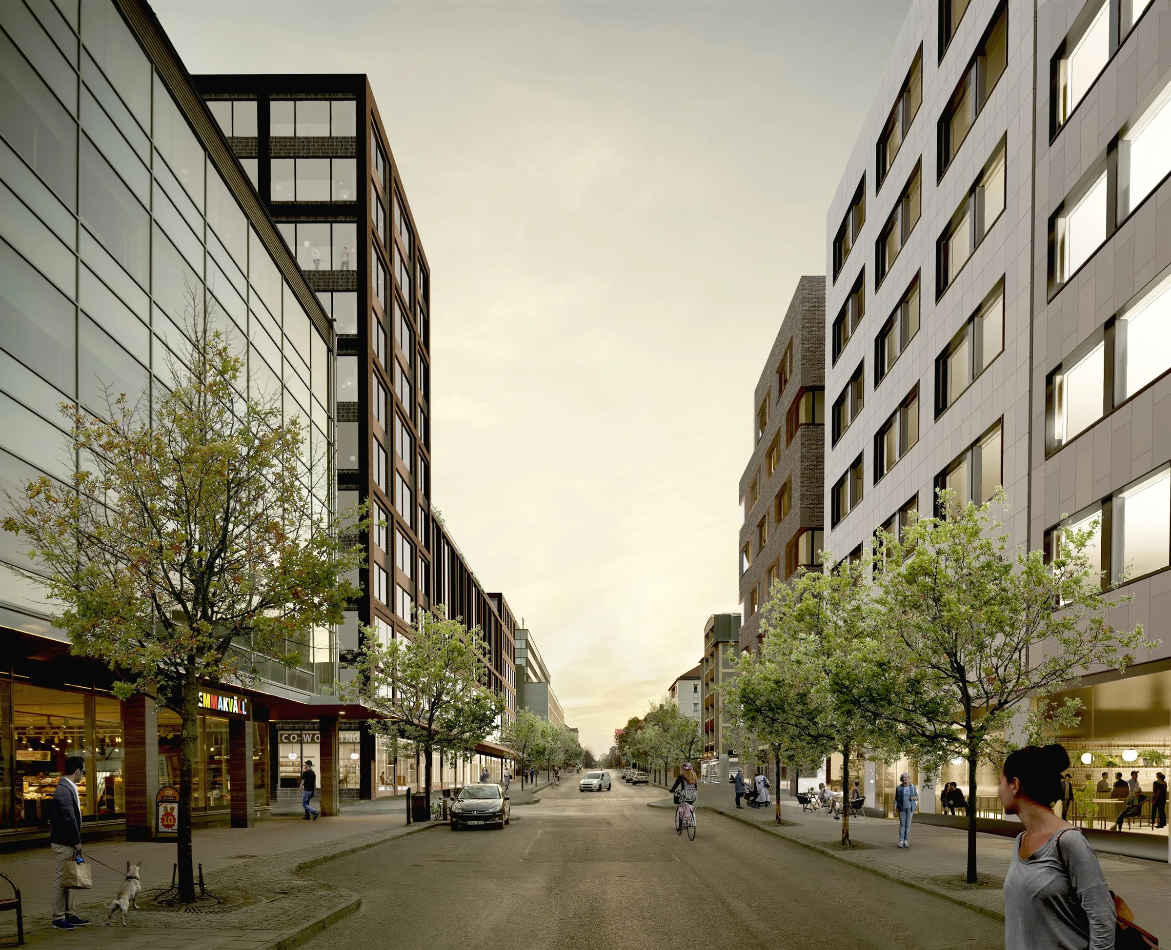 - En stadsgata kantad av moderna byggnader med glasfasader och träd, med människor och bilar på vägen.